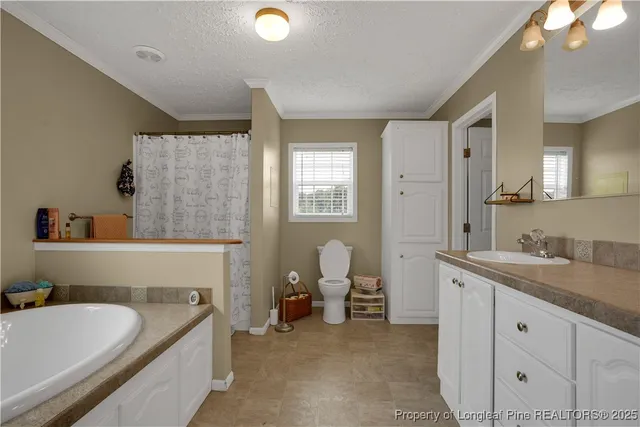 a bathroom with a granite countertop sink and a bathtub