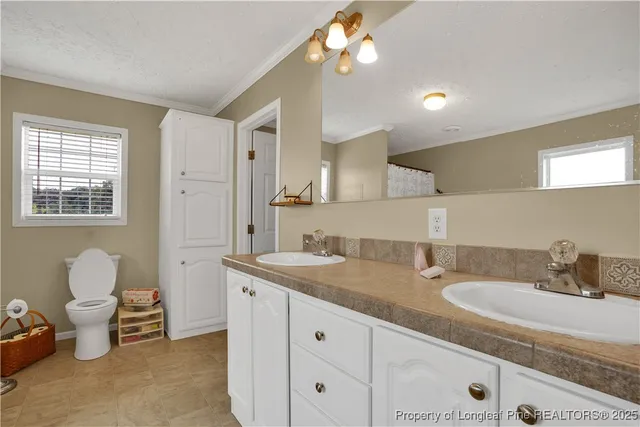 a bathroom with a granite countertop sink a toilet and a mirror