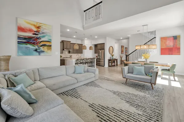 a living room with furniture and a view of kitchen
