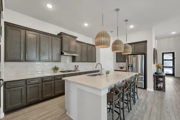 a kitchen with lots of counter space a sink appliances and cabinets