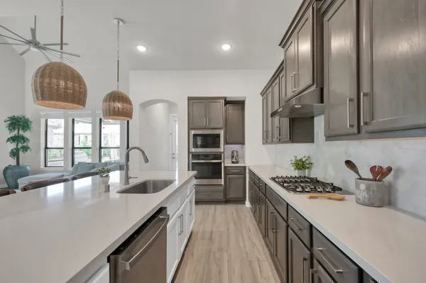 a kitchen with stainless steel appliances granite countertop a lot of counter space cabinets and furniture