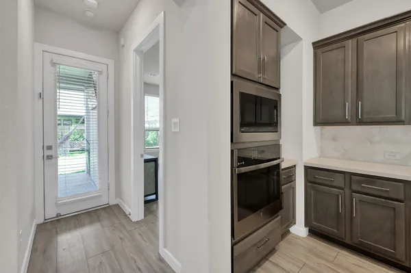 a kitchen with granite countertop stainless steel appliances and wooden cabinets