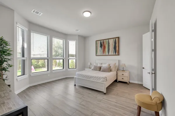 a bedroom with a bed and a couch