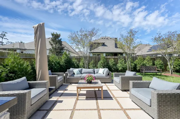 a view of a house with backyard sitting area and garden