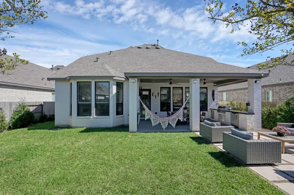 a view of a house with backyard porch and garden