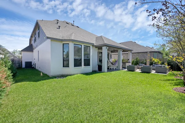 a front view of a house with a porch and a garden