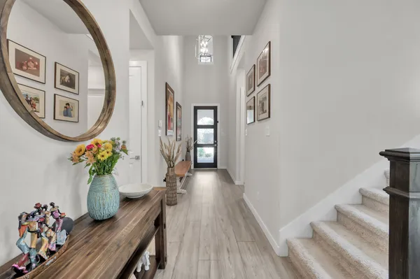 a view of a hallway with wooden floor and entryway