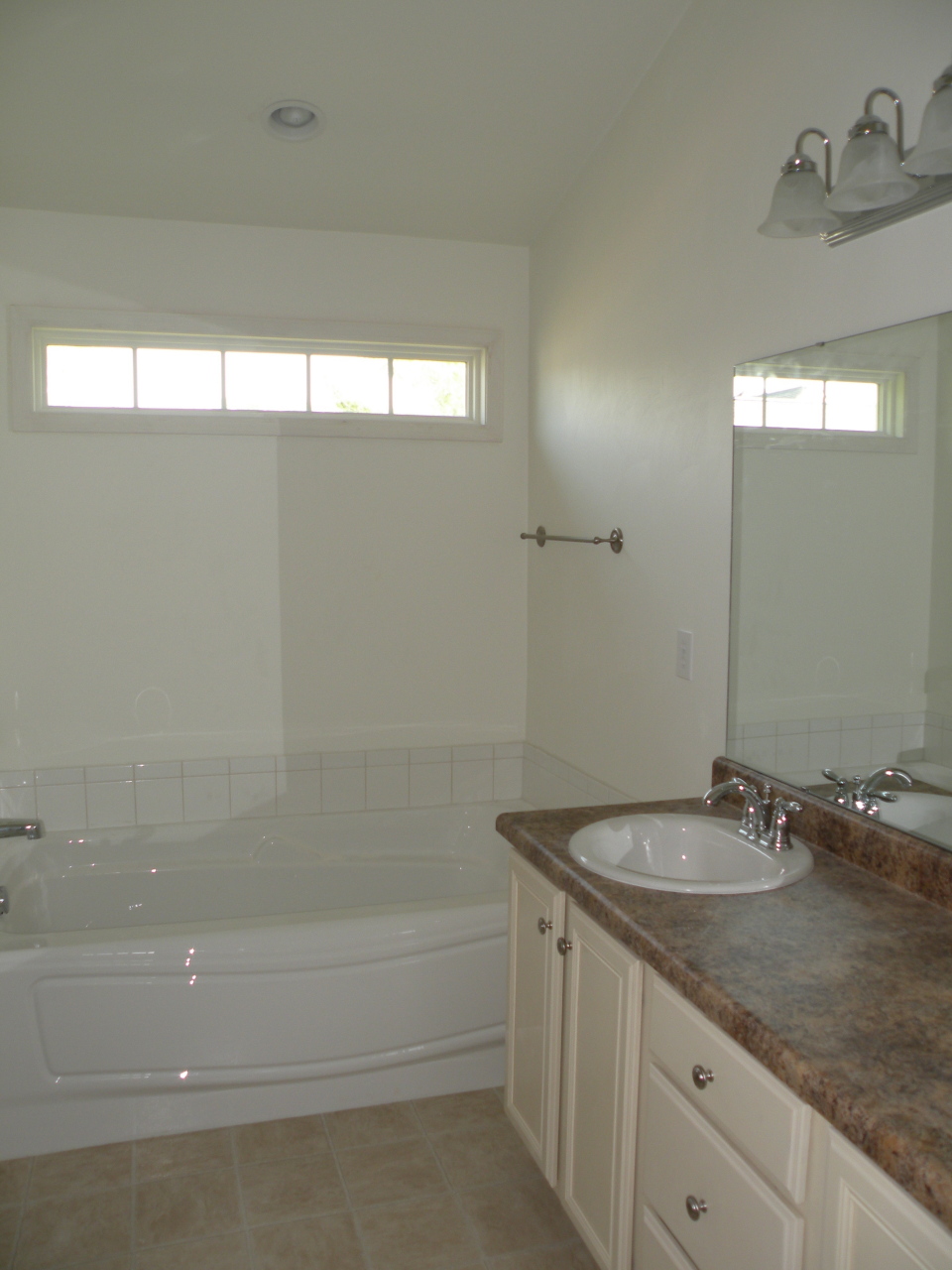 5537 Cove Road Roanoke, VA 24019 - Photo 16 of 28 a bathroom with a granite countertop sink a mirror and a bathtub