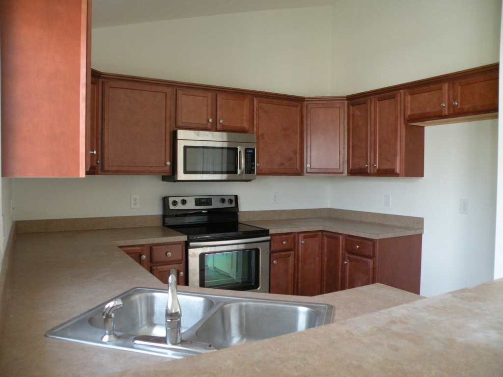 5537 Cove Road Roanoke, VA 24019 - Photo 10 of 28 a kitchen with a sink a microwave and cabinets