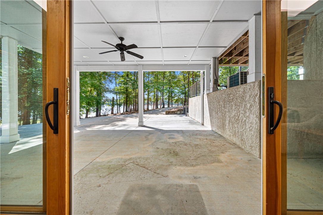 285 Bertha Allen Road Westminster, SC 29693 - Photo 22 of 50 A spacious covered patio invites relaxation, with lake views framed by mature trees.
