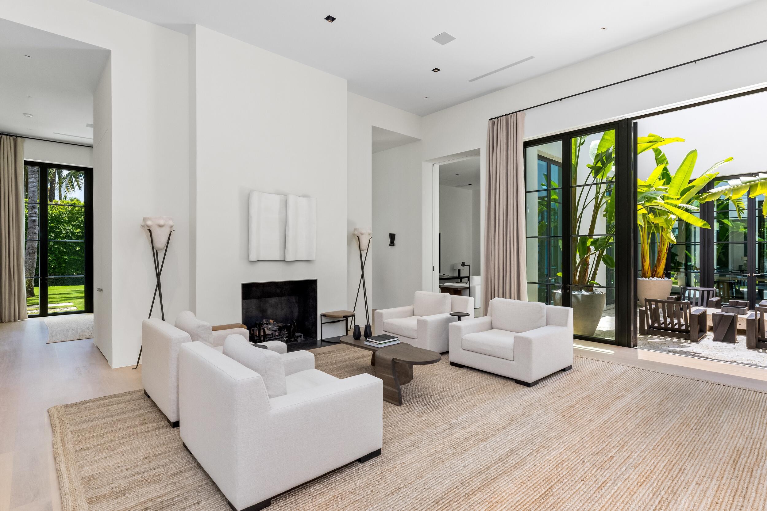 241 Jungle Road Palm Beach, FL 33480 - Photo 11 of 96 a living room with furniture a fireplace and a large window