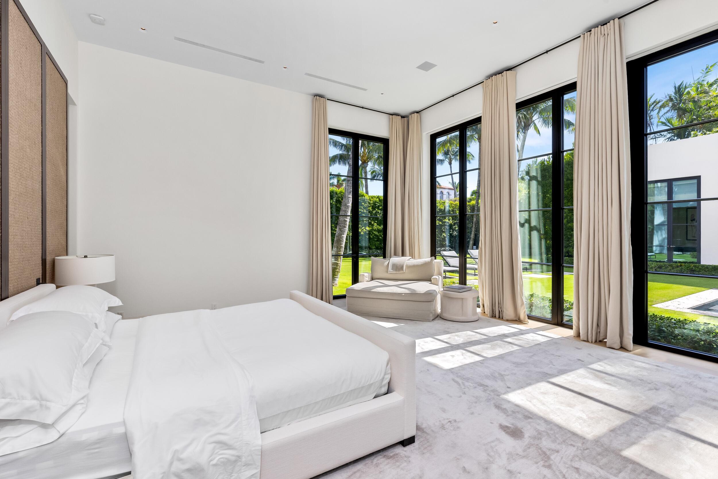 241 Jungle Road Palm Beach, FL 33480 - Photo 49 of 96 a bedroom with a large bed and a large window