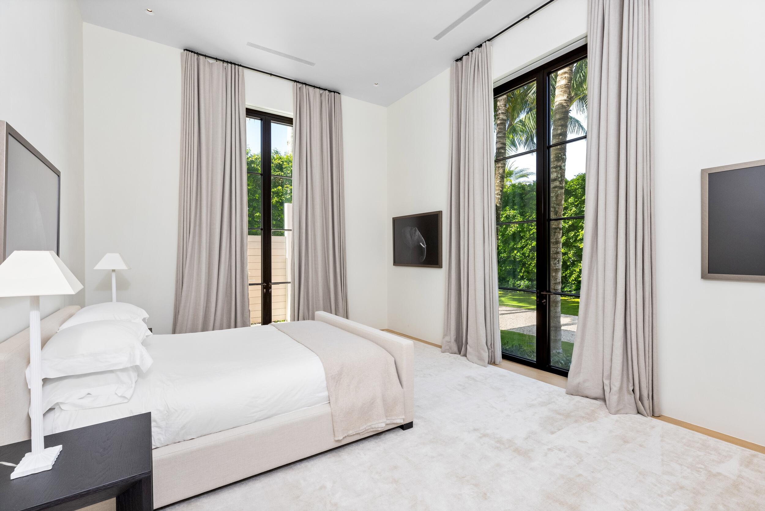 241 Jungle Road Palm Beach, FL 33480 - Photo 54 of 96 a bedroom with a large bed and a large window