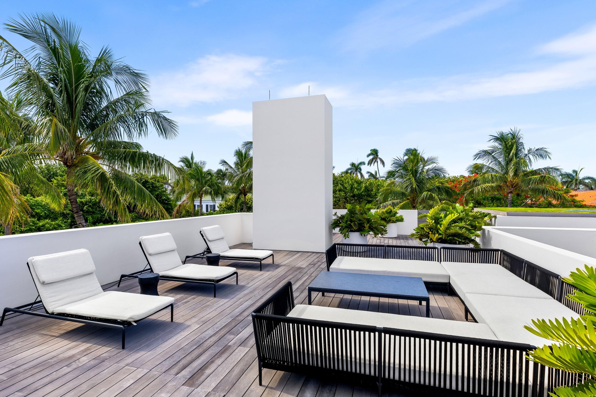 241 Jungle Road Palm Beach, FL 33480 - Photo 64 of 96 a view of a patio with couches and potted plants