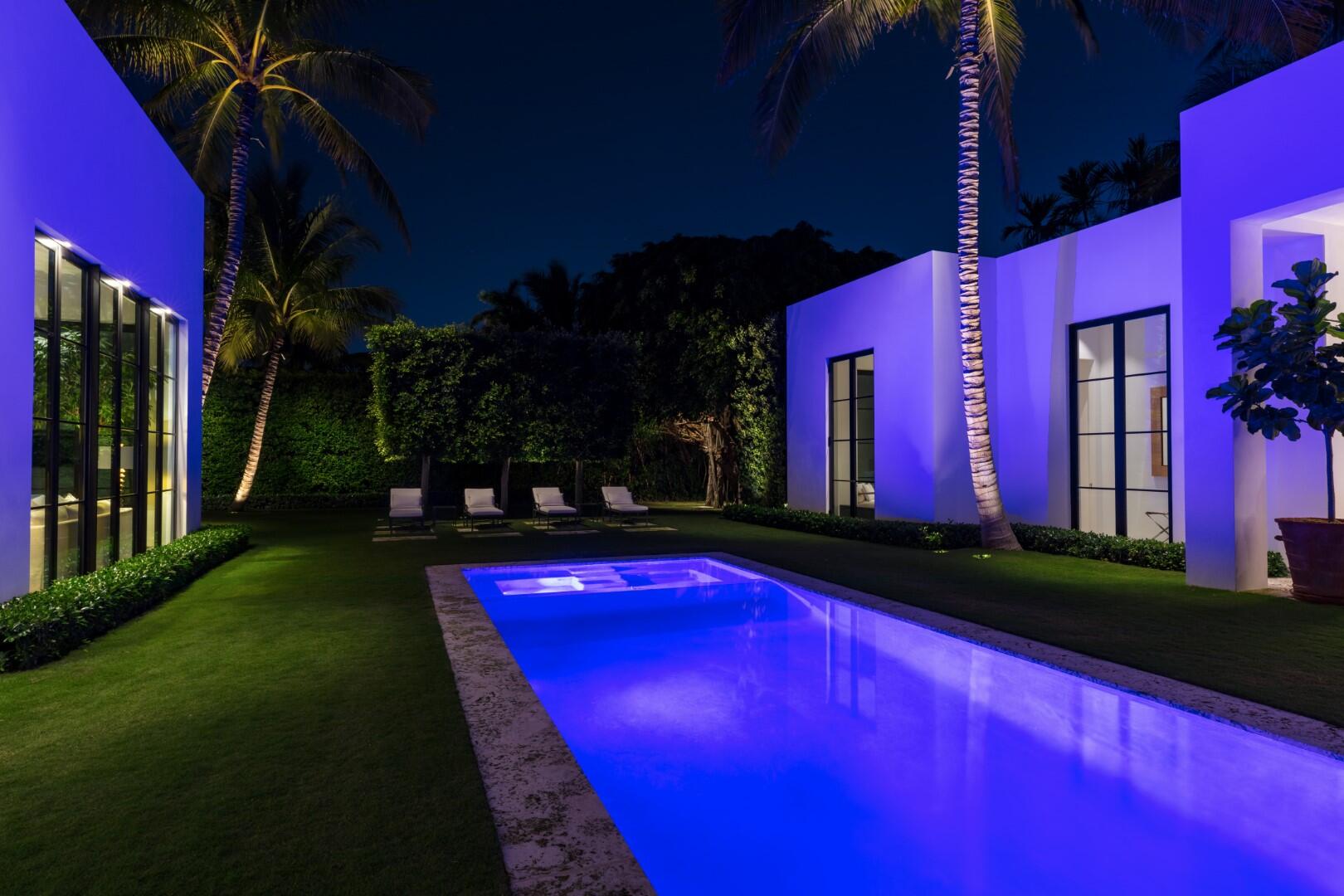241 Jungle Road Palm Beach, FL 33480 - Photo 80 of 96 a view of swimming pool in a yard with lawn chairs and potted plants