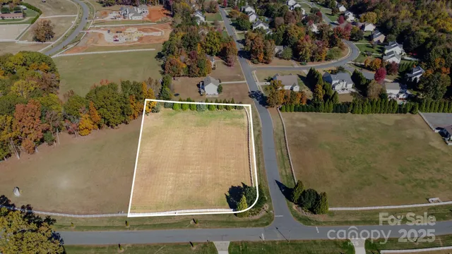 an aerial view of a residential houses with outdoor space