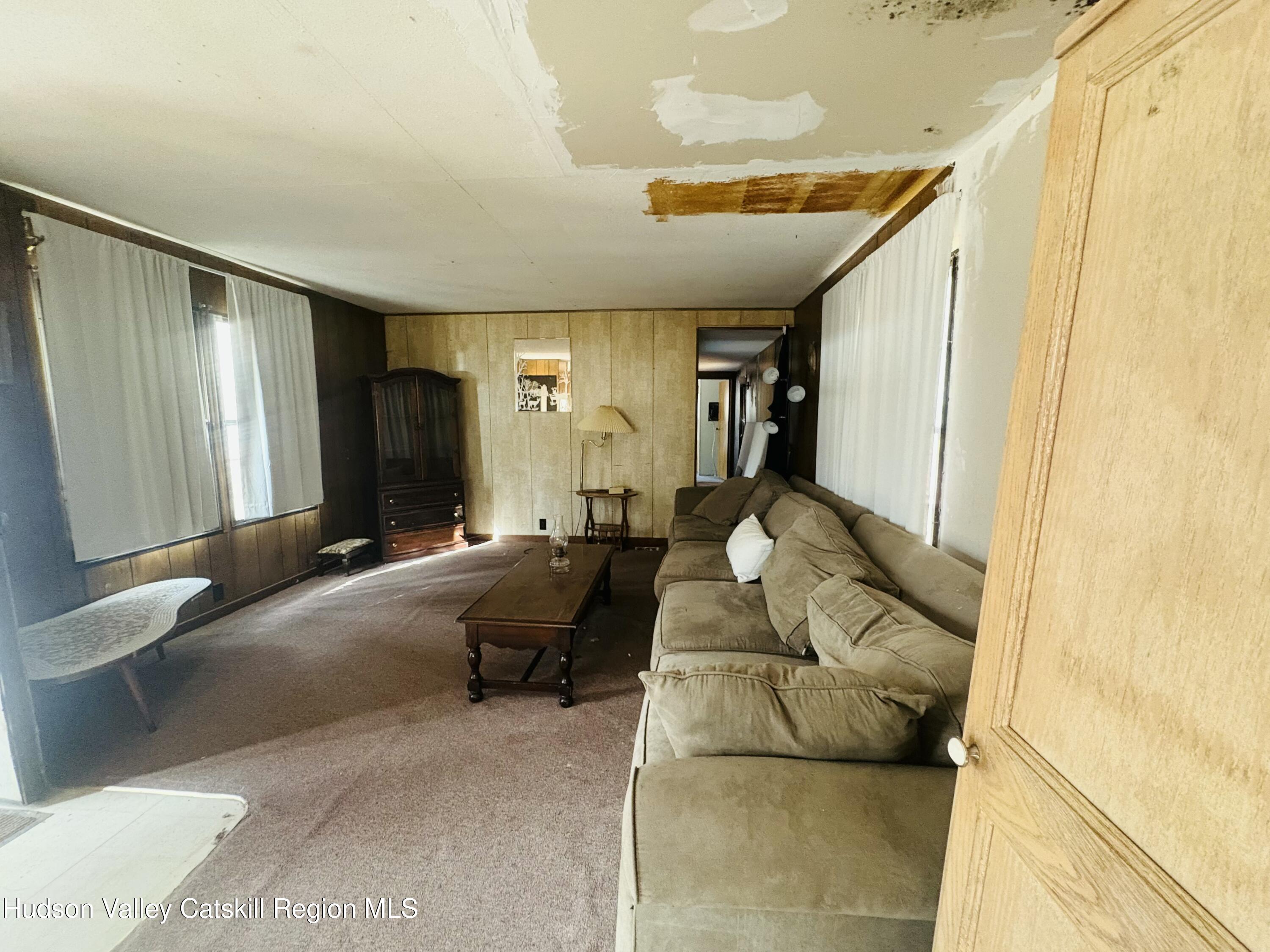 238 Buel Road Gilboa, NY 12076 - Photo 6 of 13 a living room with furniture and a large window