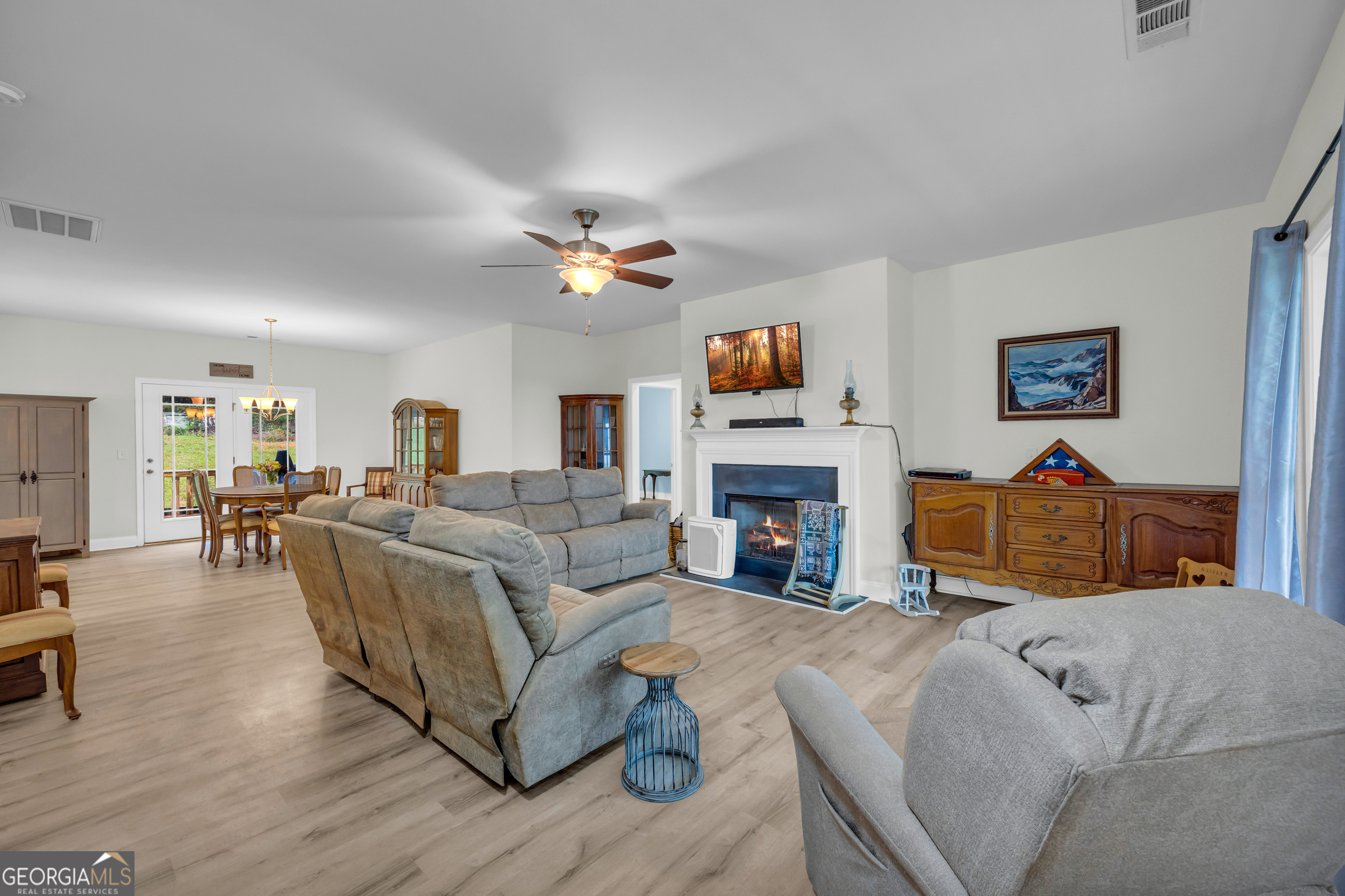 945 Hank Fry Road Clarkesville, GA 30523 - Photo 14 of 45 a living room with furniture a fireplace and a flat screen tv