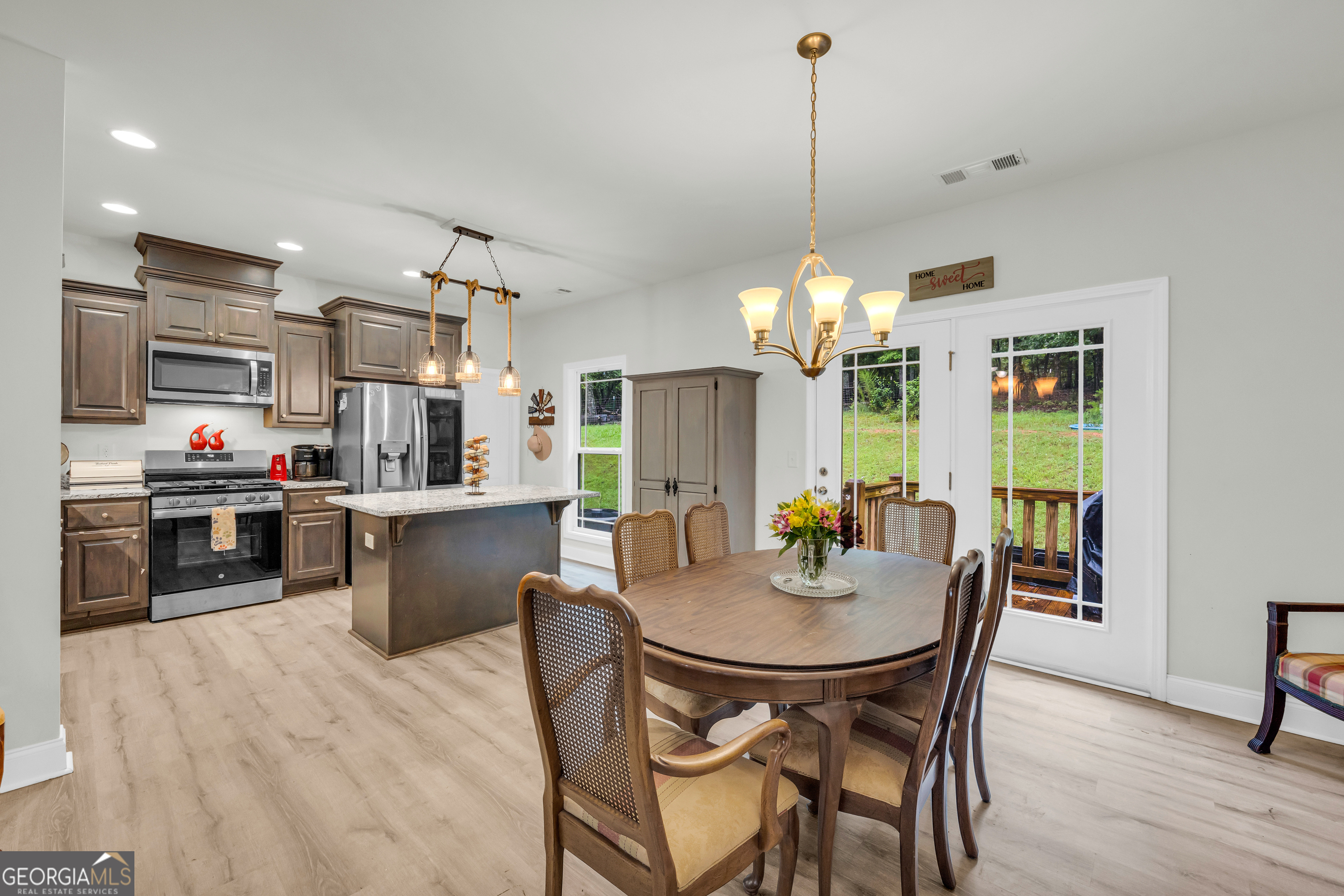 945 Hank Fry Road Clarkesville, GA 30523 - Photo 19 of 45 a view of a dining room with furniture window and wooden floor