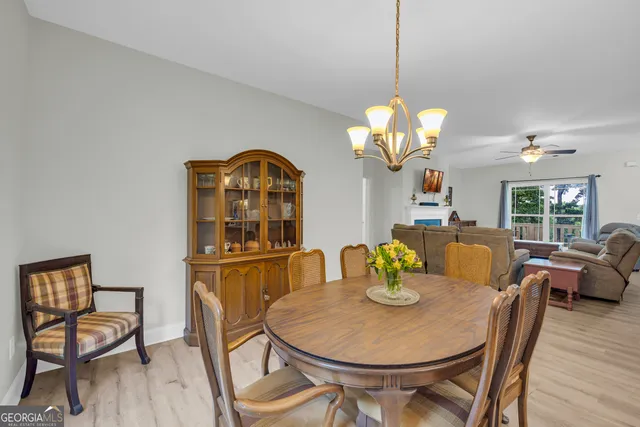 a dining room with furniture and wooden floor