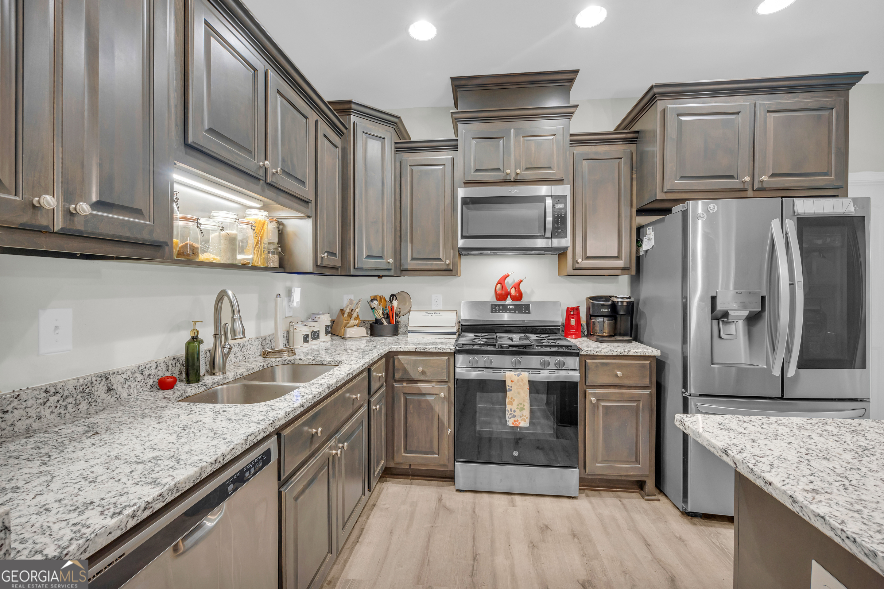 945 Hank Fry Road Clarkesville, GA 30523 - Photo 21 of 45 a kitchen with stainless steel appliances granite countertop a sink stove microwave and refrigerator