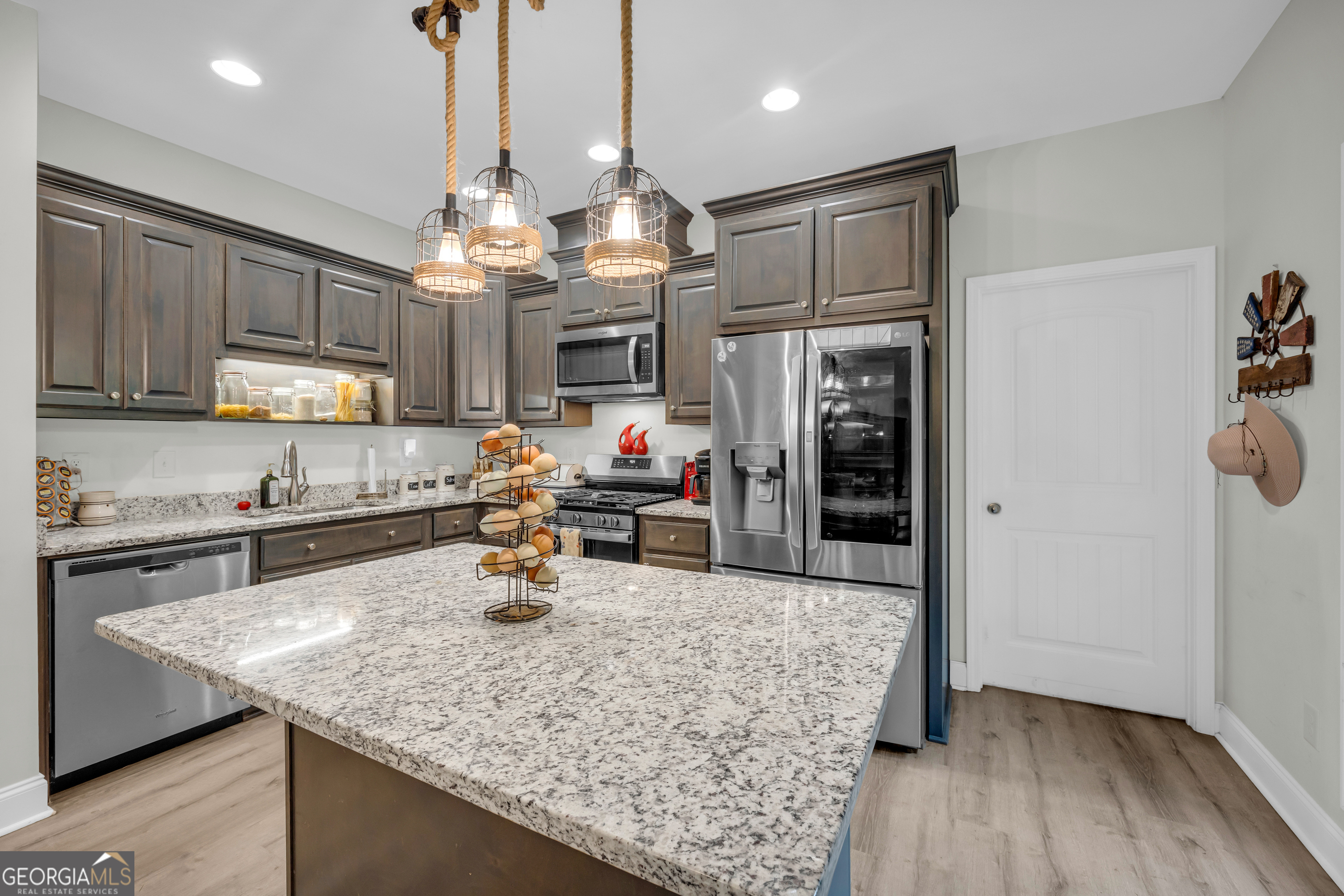 945 Hank Fry Road Clarkesville, GA 30523 - Photo 25 of 45 a kitchen with stainless steel appliances granite countertop a sink refrigerator and microwave