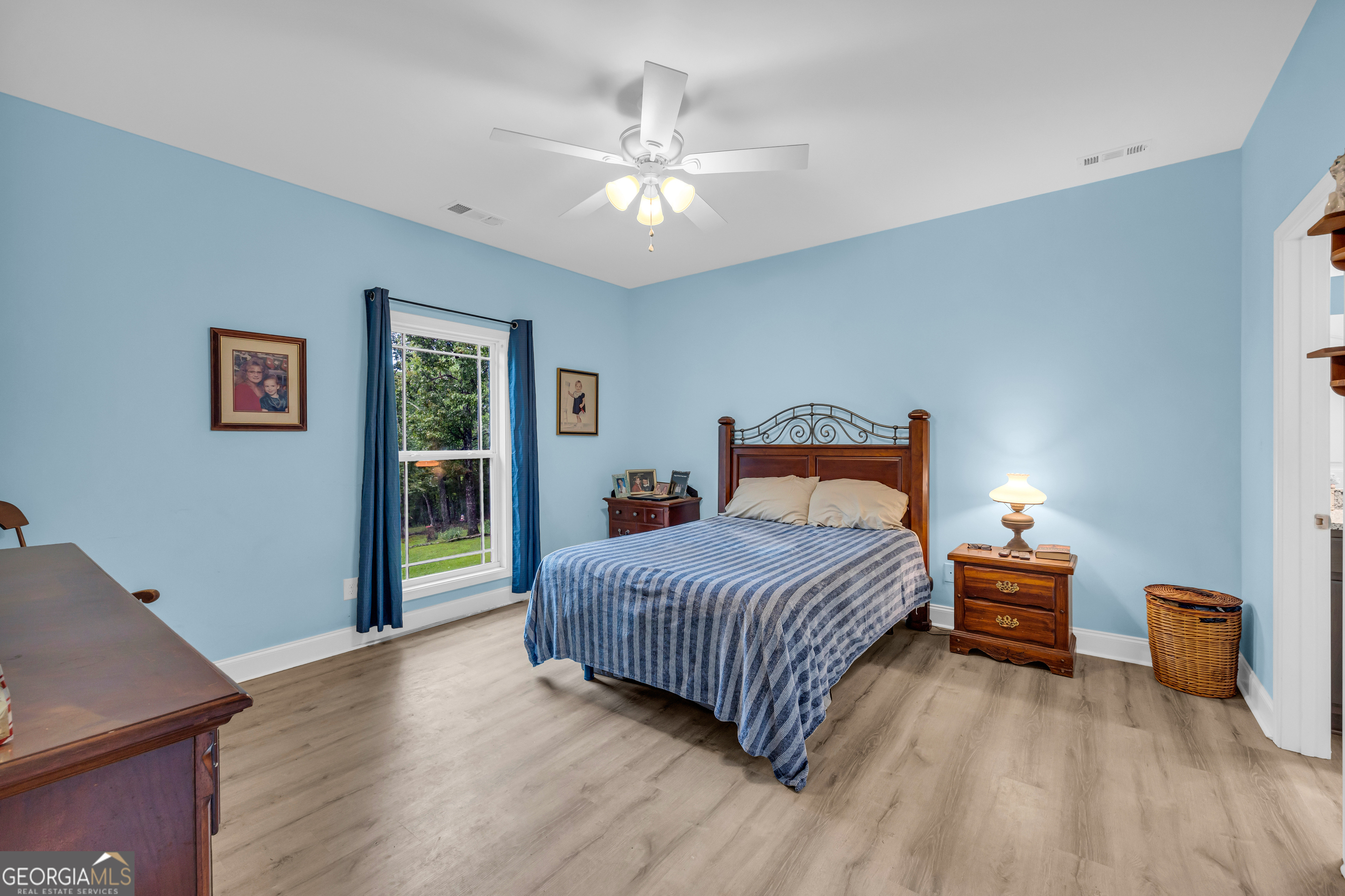 945 Hank Fry Road Clarkesville, GA 30523 - Photo 27 of 45 a bedroom with a bed and a chandelier