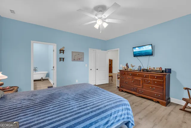 a bedroom with a bed and a dresser