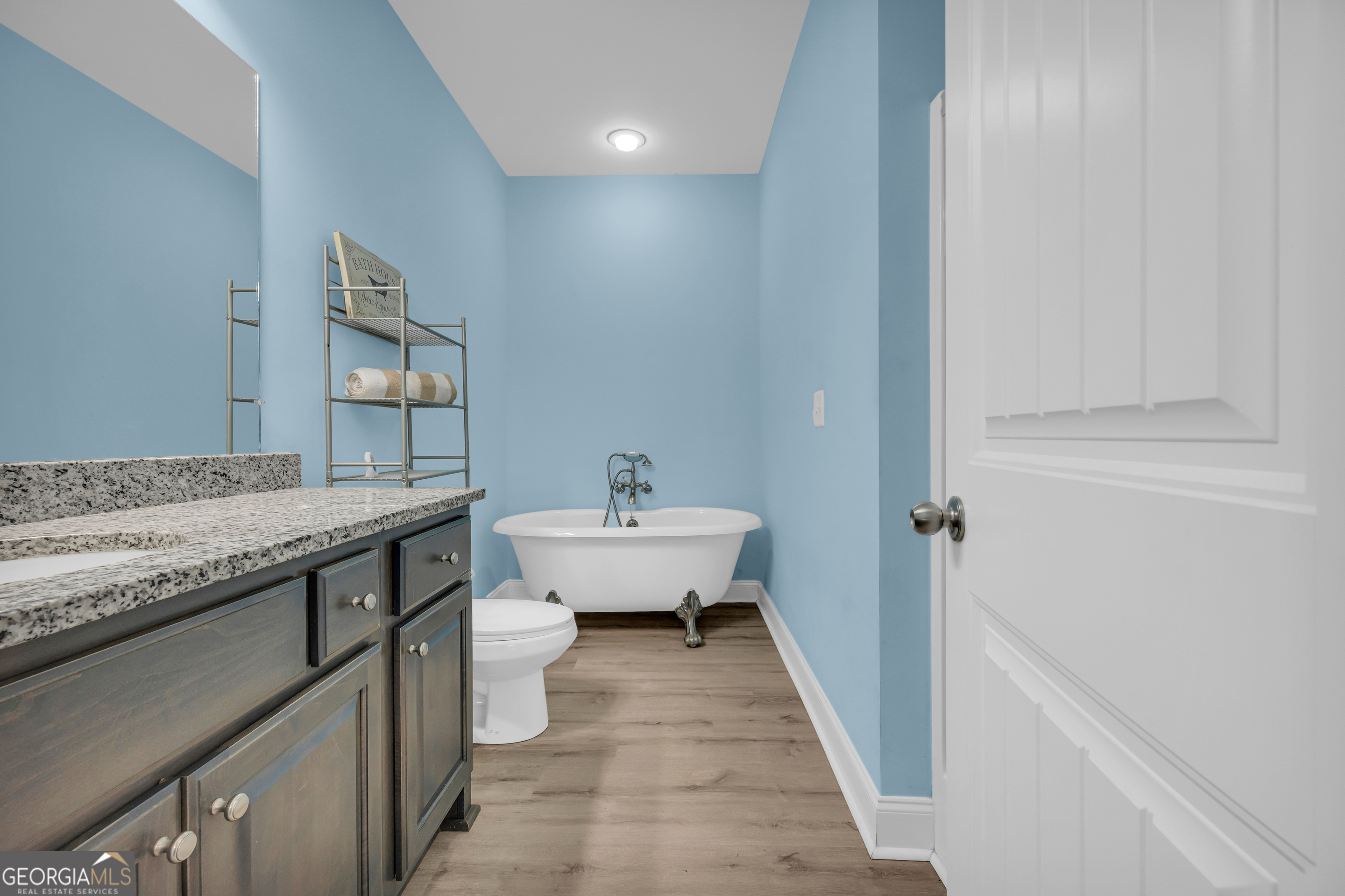 945 Hank Fry Road Clarkesville, GA 30523 - Photo 31 of 45 a bathroom with a granite countertop sink a toilet and bathtub