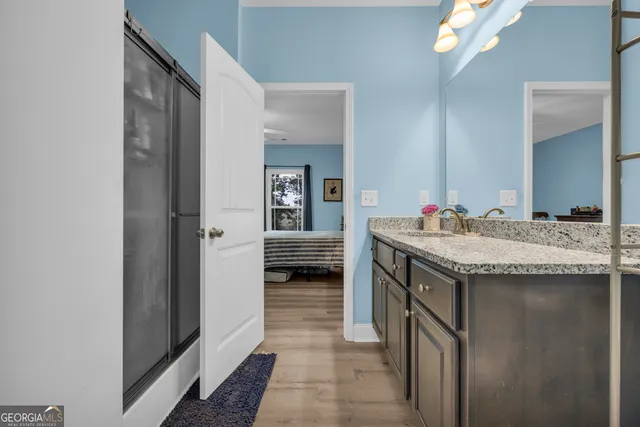 a bathroom with a granite countertop sink and a mirror