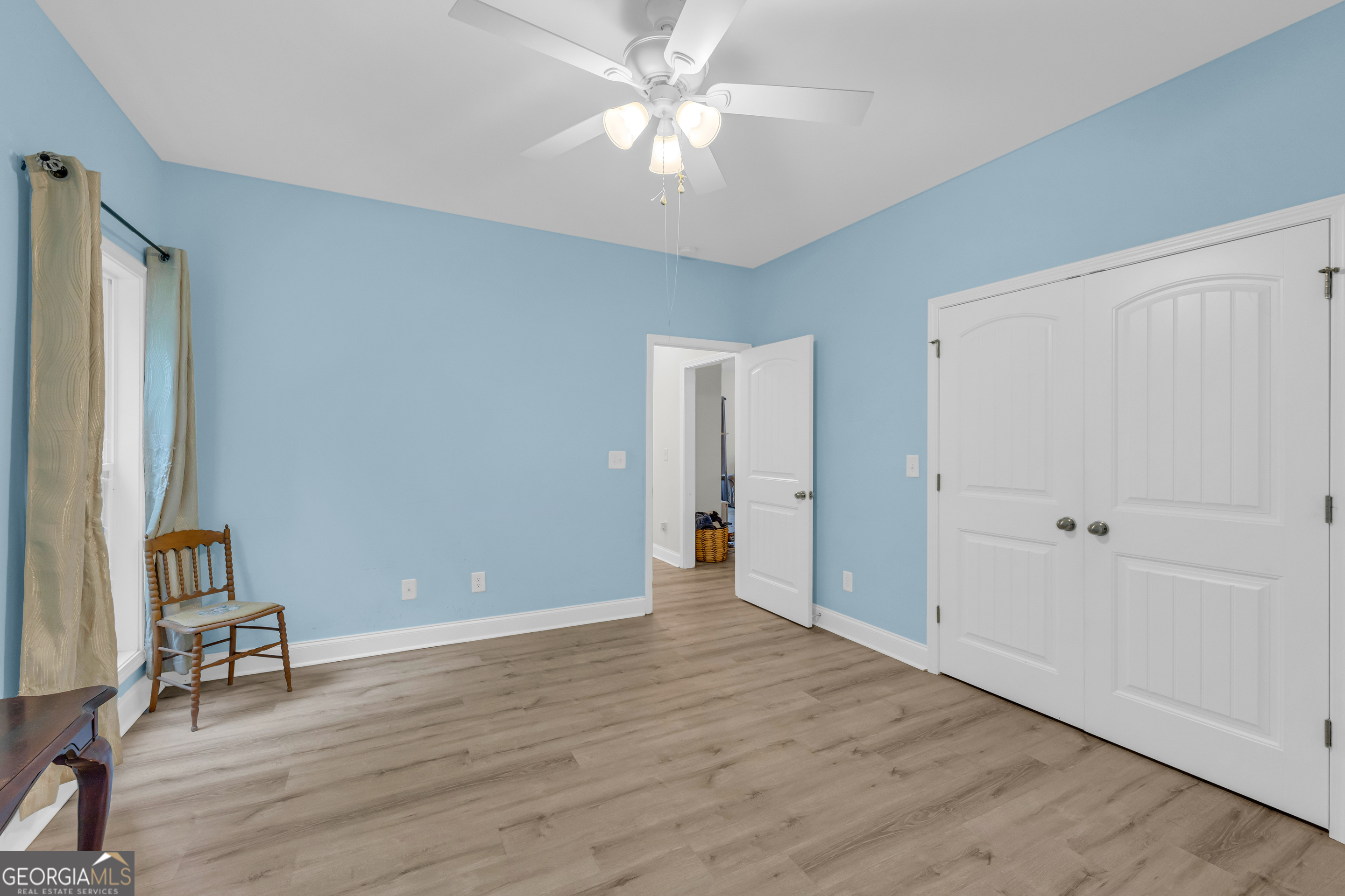 945 Hank Fry Road Clarkesville, GA 30523 - Photo 35 of 45 an empty room with wooden floor and a ceiling fan