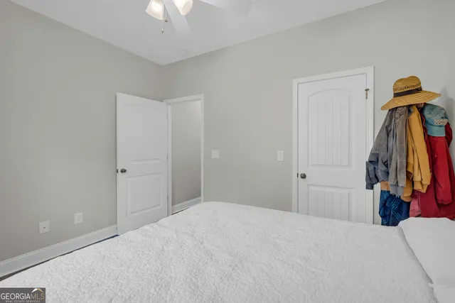 a bedroom with a bed and a chandelier