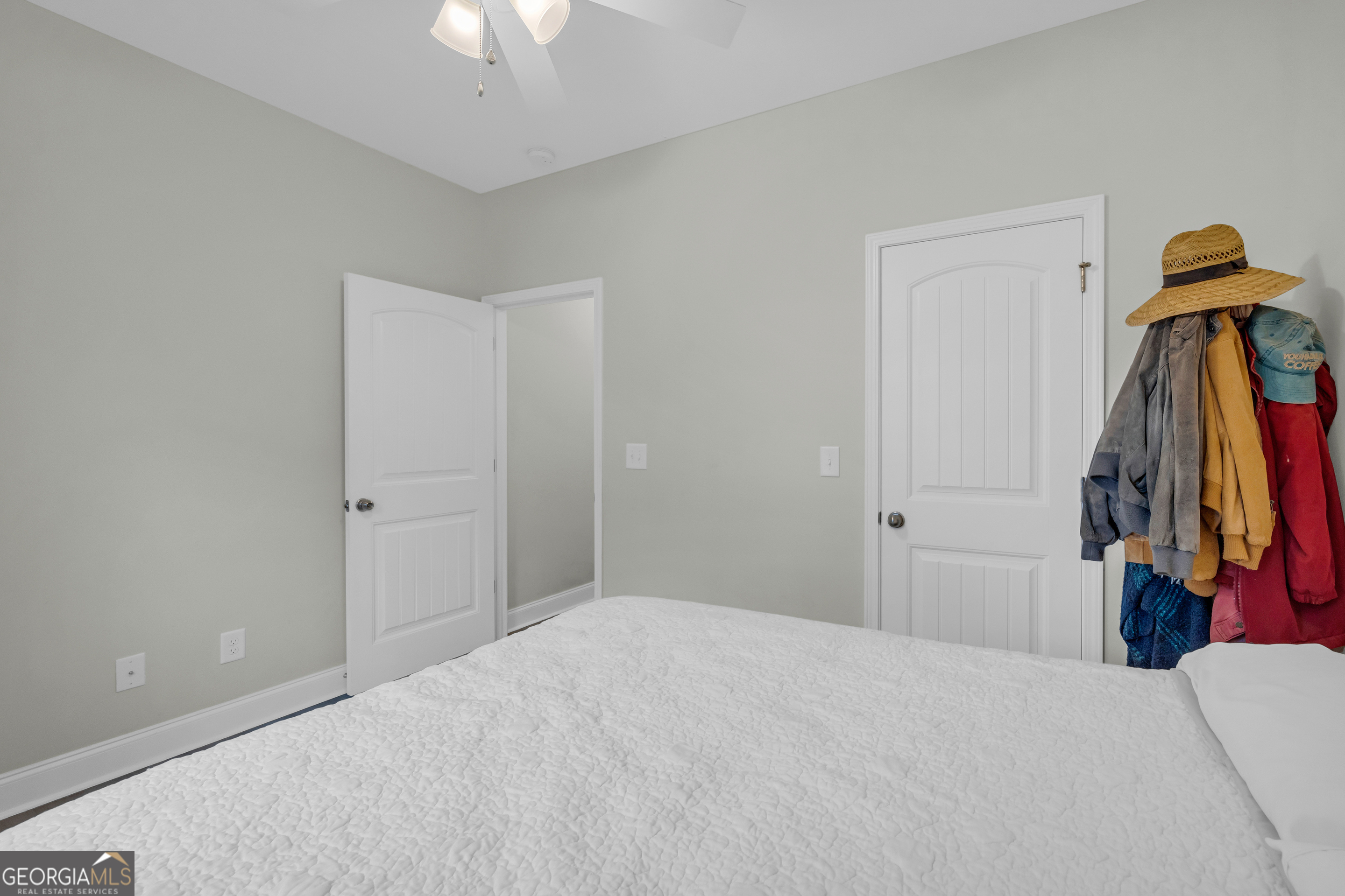 945 Hank Fry Road Clarkesville, GA 30523 - Photo 38 of 45 a bedroom with a bed and a chandelier