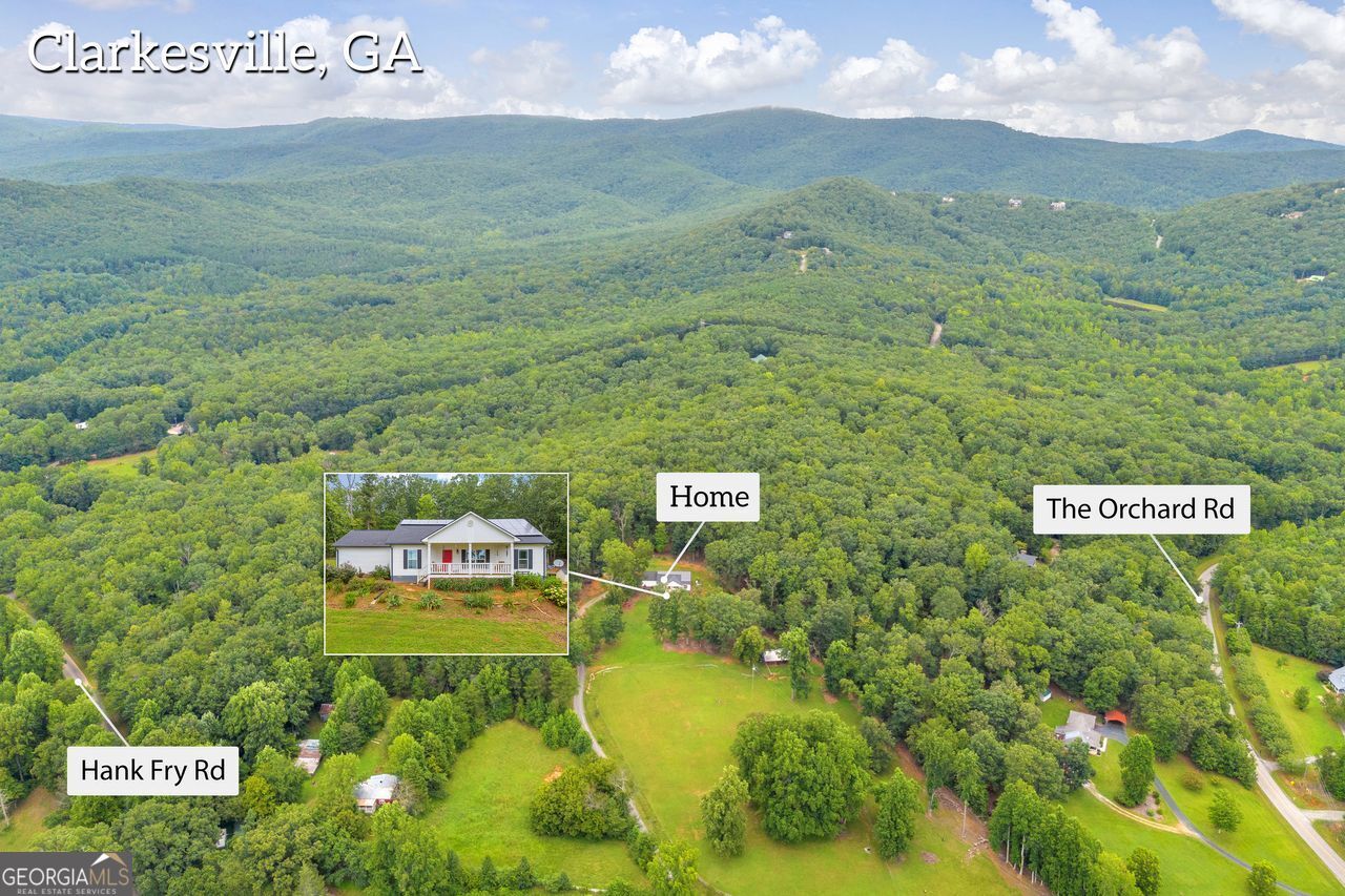 945 Hank Fry Road Clarkesville, GA 30523 - Photo 5 of 45 a view of a sign board with yard and mountain view