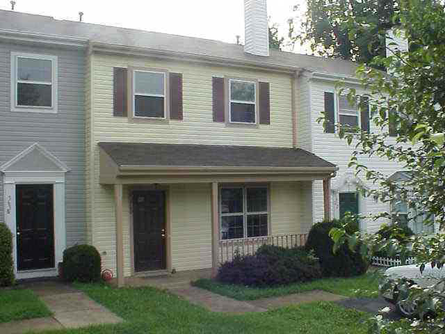 a view of a house with a yard and plants