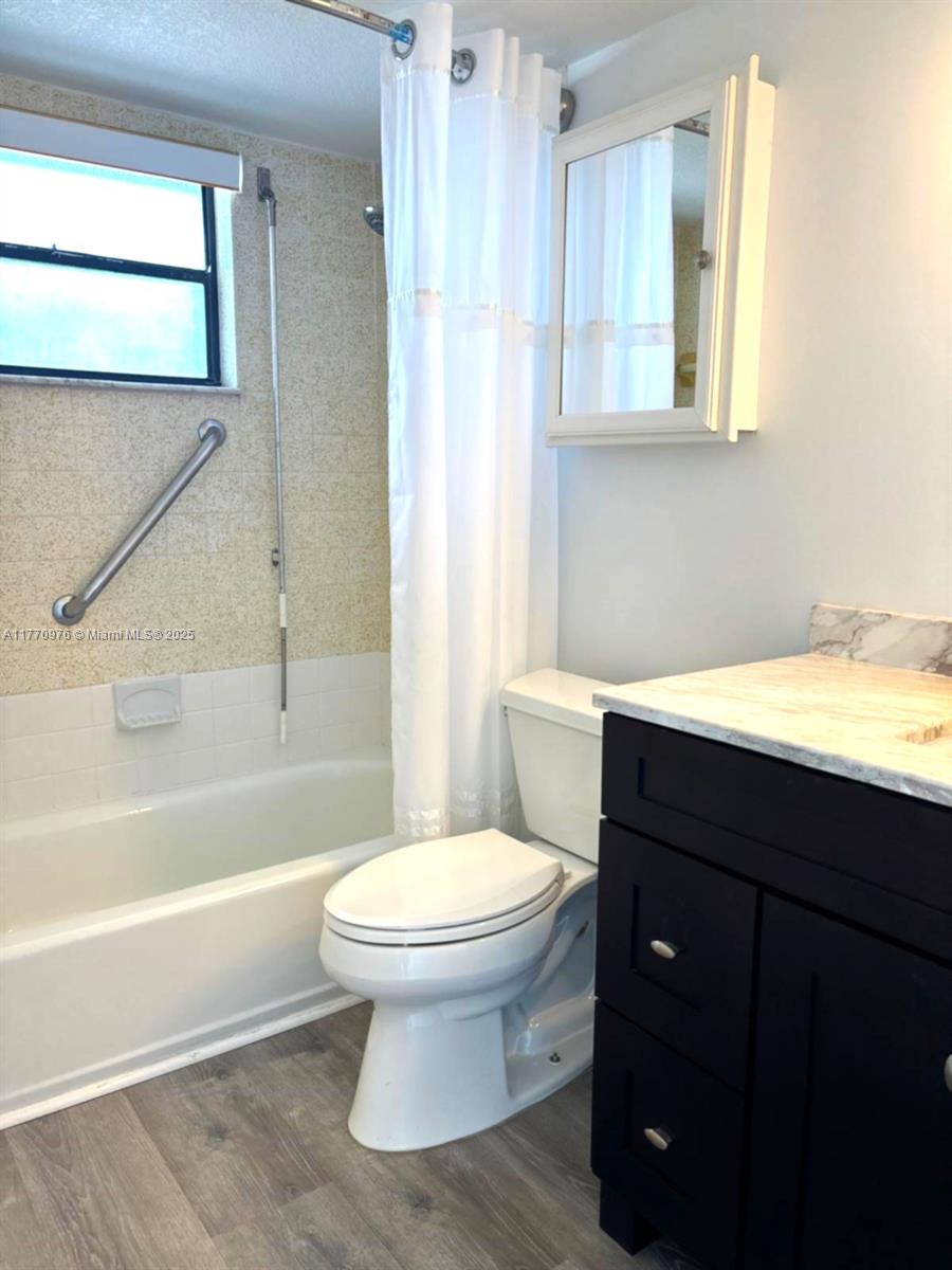 7300 Wayne Avenue, Unit 511 Miami Beach, FL 33141 - Photo 11 of 20 a bathroom with a sink toilet and bathtub