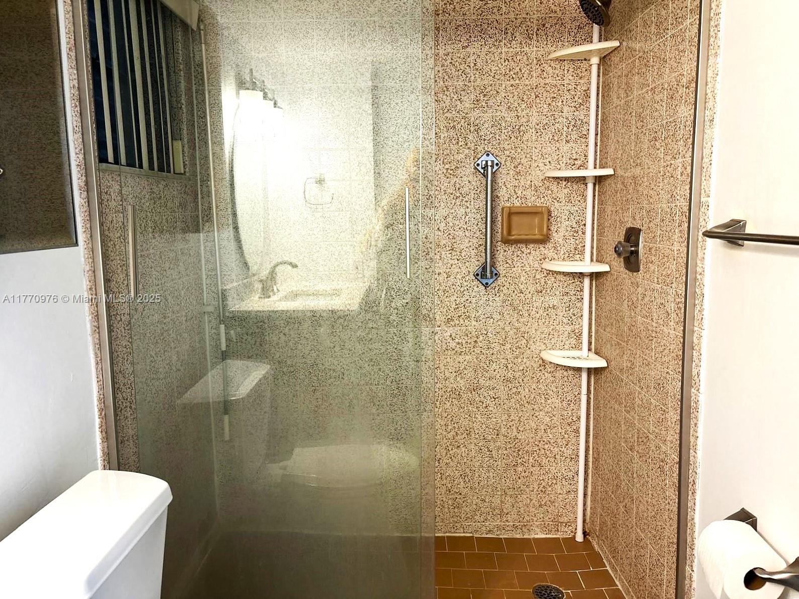 7300 Wayne Avenue, Unit 511 Miami Beach, FL 33141 - Photo 13 of 20 a bathroom with a shower and toilet