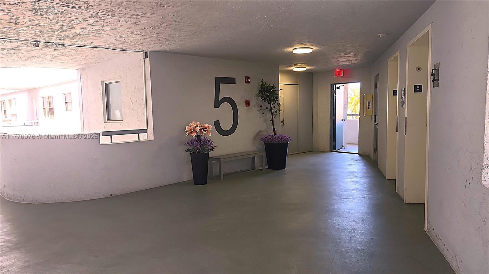 7300 Wayne Avenue, Unit 511 Miami Beach, FL 33141 - Photo 7 of 20 a view of a hallway with wooden floor and windows
