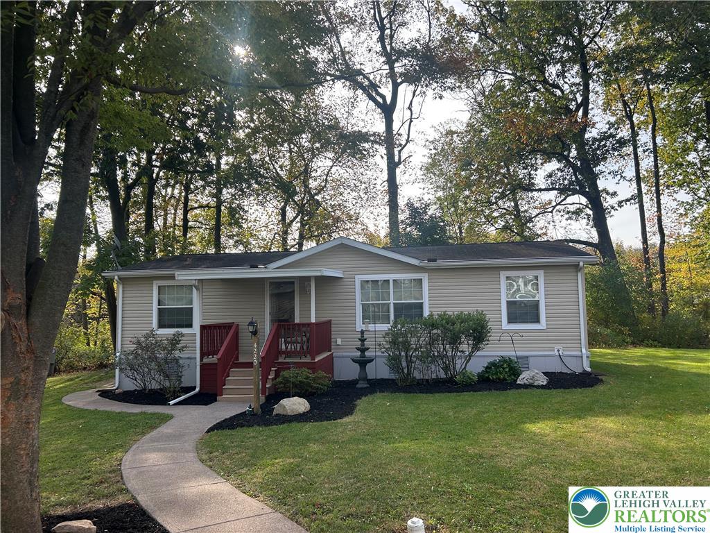 a view of a house with backyard sitting area and garden