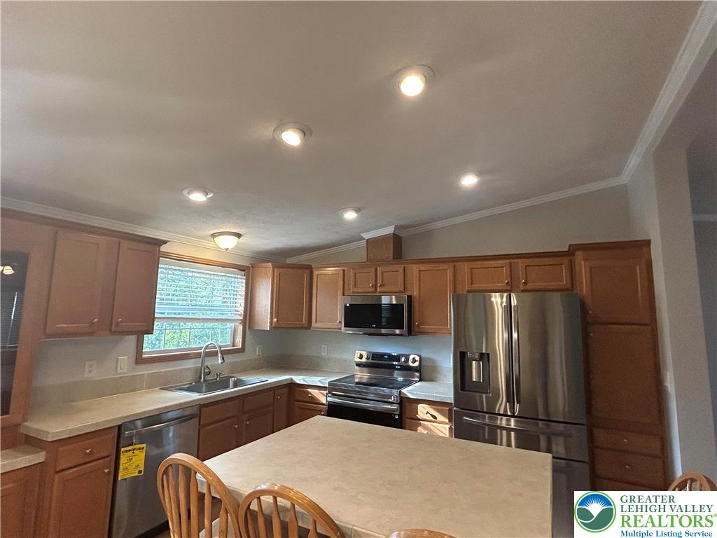 4220 Panther Court Orefield, PA 18069 - Photo 8 of 21 a kitchen with granite countertop a refrigerator and a sink
