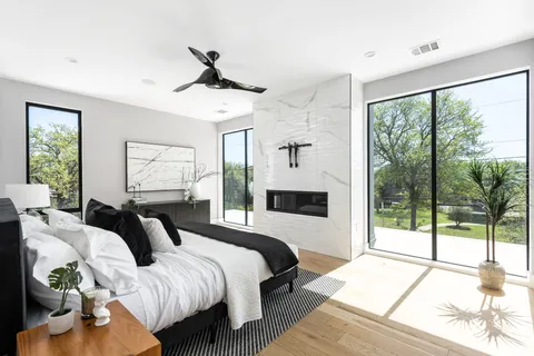 a bedroom with bed and a large window