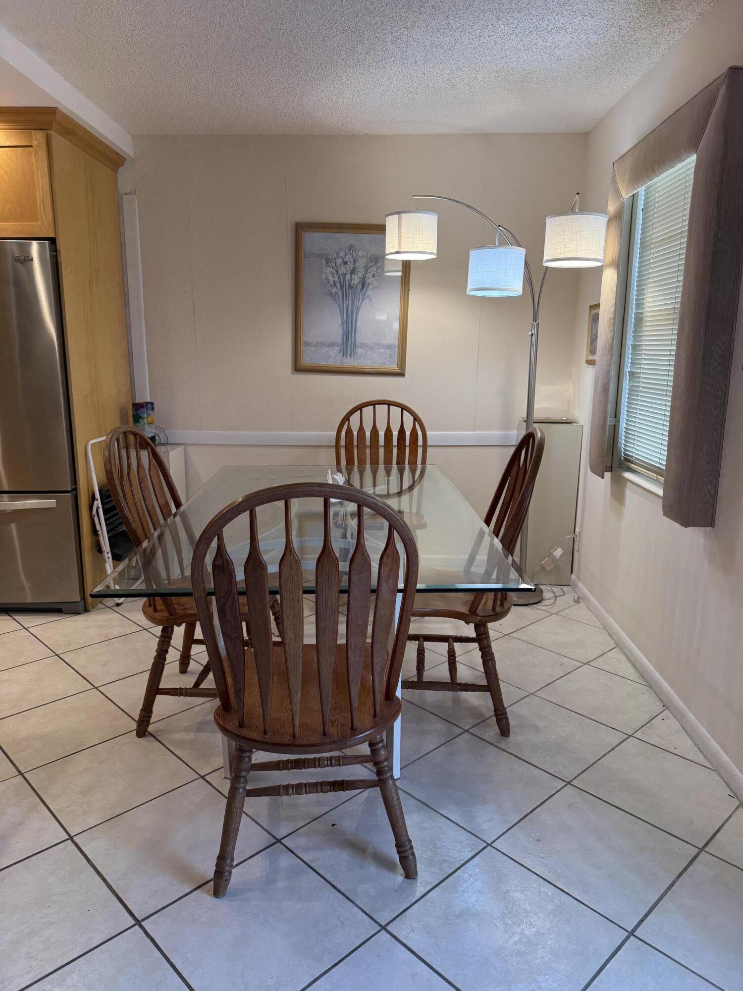 1046 Wolverton C Boca Raton, FL 33434 - Photo 5 of 17 a view of a dining room with furniture