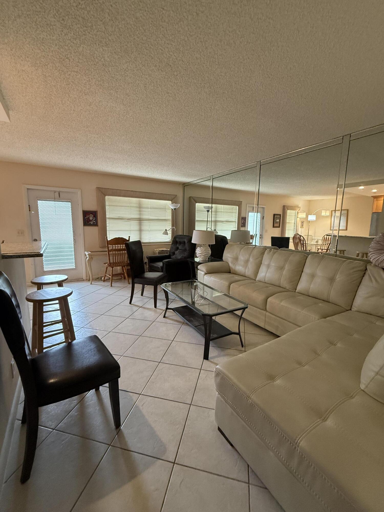 1046 Wolverton C Boca Raton, FL 33434 - Photo 7 of 17 a living room with furniture and a window