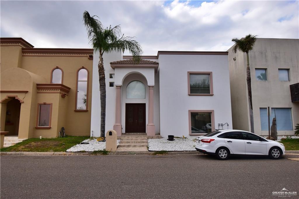 Mediterranean / spanish-style house with stucco siding and a tiled roof