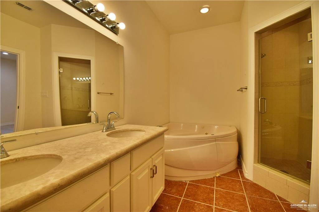 1104 Rio Balsas Mission, TX 78572 - Photo 11 of 20 Full bathroom with double vanity, a bath, a stall shower, dark tile patterned floors, and recessed lighting
