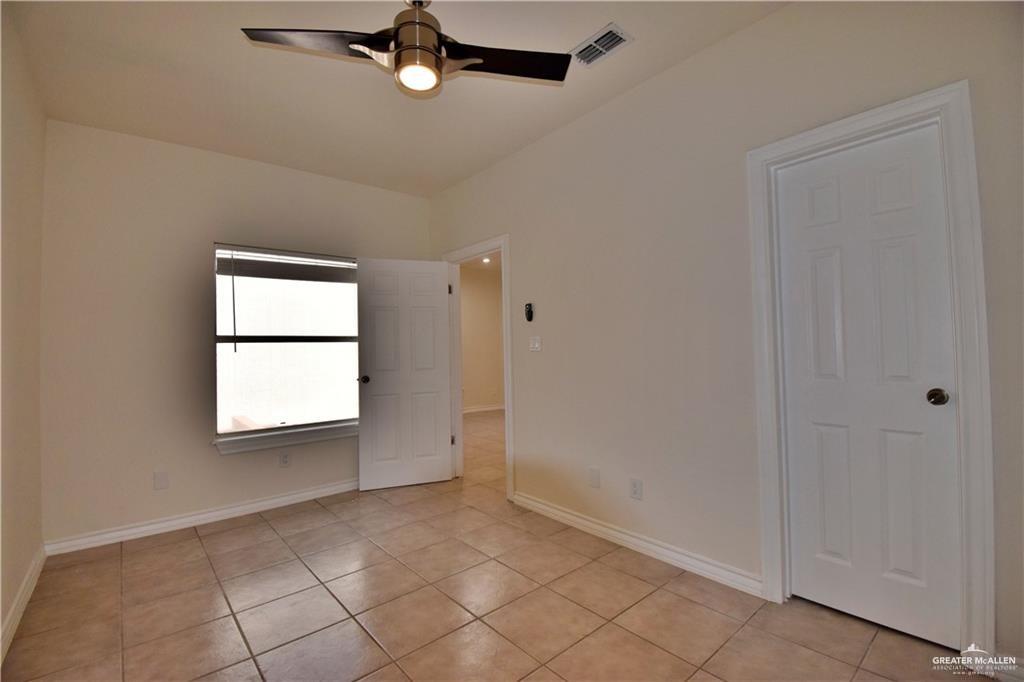 1104 Rio Balsas Mission, TX 78572 - Photo 14 of 20 Empty room with light tile patterned floors and a ceiling fan