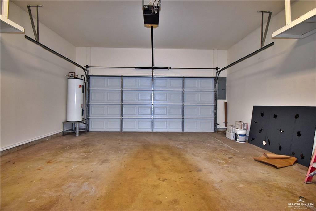 1104 Rio Balsas Mission, TX 78572 - Photo 18 of 20 Garage featuring water heater, a garage door opener, and electric panel