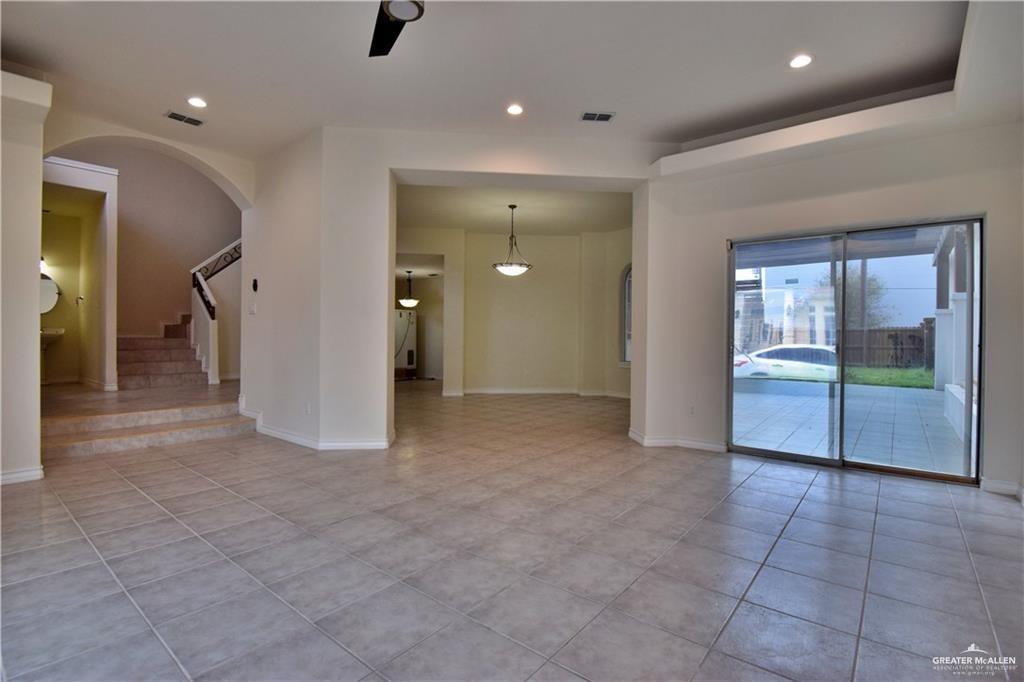 1104 Rio Balsas Mission, TX 78572 - Photo 2 of 20 Spare room featuring arched walkways, recessed lighting, stairway, a ceiling fan, and light tile patterned flooring