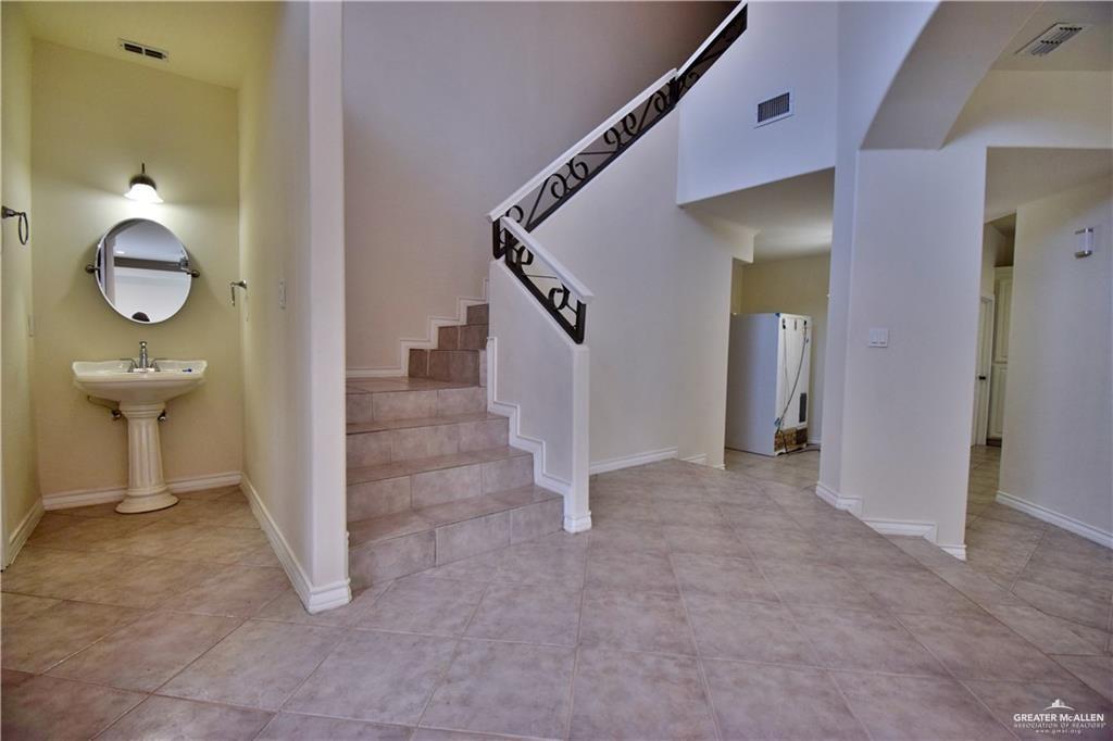 1104 Rio Balsas Mission, TX 78572 - Photo 6 of 20 Stairway with baseboards and tile patterned flooring