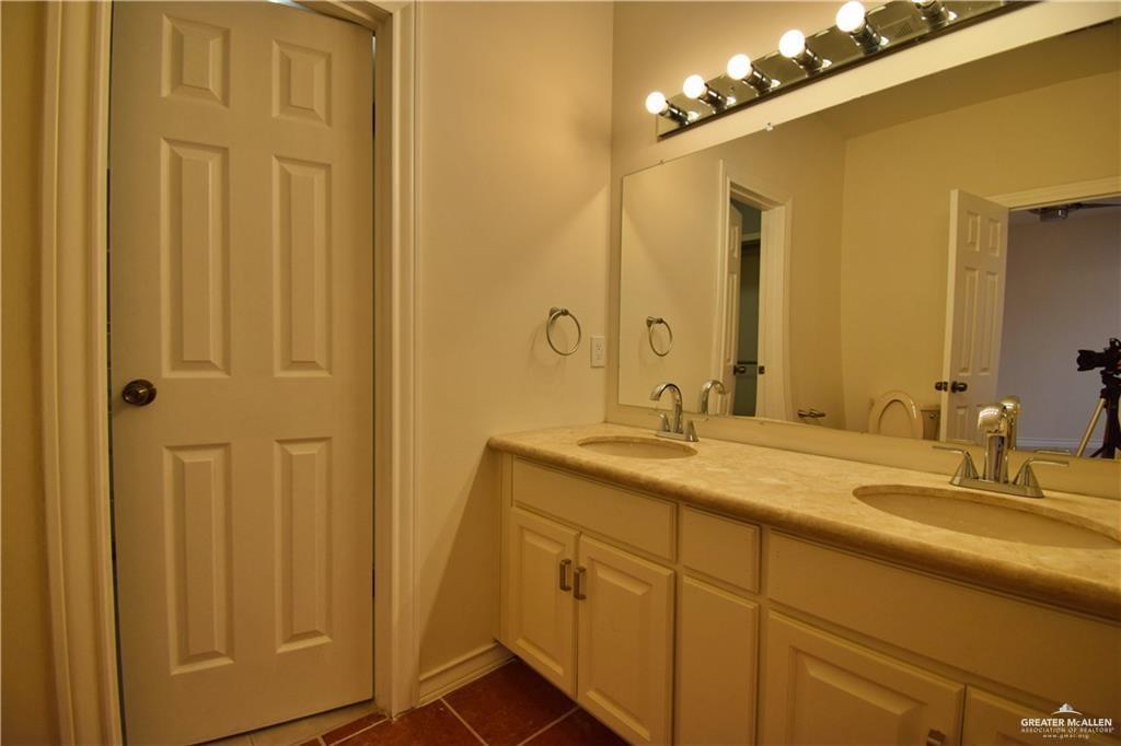 1104 Rio Balsas Mission, TX 78572 - Photo 10 of 20 Full bath with double vanity and dark tile patterned flooring